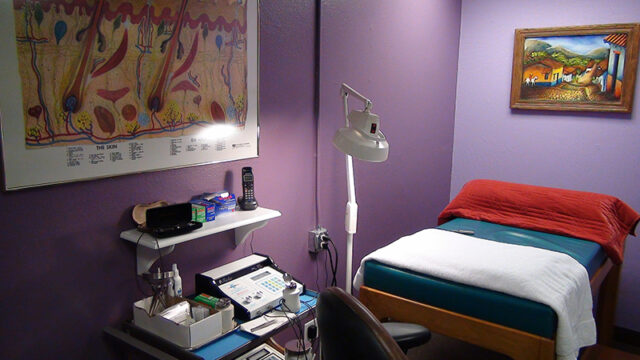 Licensed electrologist performing electrolysis treatment in a clinical setting.